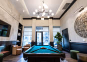 Thumbnail 37 of 53 - a pool table sits in the middle of a room with a large chandelier above it