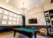 Thumbnail 36 of 53 - a game room with a pool table and a tv