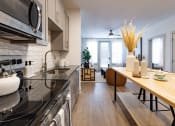 Thumbnail 42 of 53 - a kitchen and dining area in a 555 waverly unit