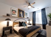 Thumbnail 26 of 53 - a bedroom with a large bed and a ceiling fan