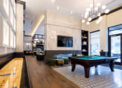 Thumbnail 39 of 53 - a game room with a pool table and a television