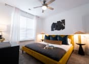 Thumbnail 46 of 53 - a bedroom with a large bed and a ceiling fan