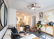 Thumbnail 48 of 53 - a living room with white walls and a ceiling fan