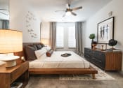 Thumbnail 44 of 53 - a bedroom with a bed and dresser in a 555 waverly unit