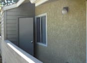 Thumbnail 2 of 16 - A picture of a 2nd story apartment balcony with a storage room door ajar and a porch light that is off.