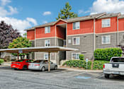 Thumbnail 25 of 74 - A red car is parked in front of a grey building  at The Timbers by Vintage, Arlington, 98223