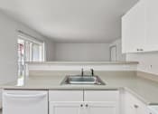 Thumbnail 73 of 74 - A kitchen with white cabinets and a sink.