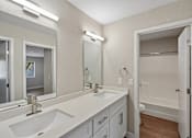 Thumbnail 22 of 22 - Modern bathroom with dual vanity sinks at Dash Apartments, Las Vegas, 89104