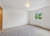 Thumbnail 62 of 74 - A room with a window and a carpeted floor.
