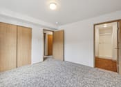 Thumbnail 55 of 74 - A room with a grey carpet and wooden doors.