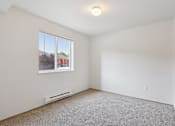 Thumbnail 60 of 74 - A room with a window and a carpeted floor.