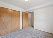 Thumbnail 63 of 74 - A room with a carpeted floor and two wooden doors.