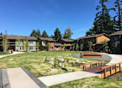 Thumbnail 21 of 25 - A park with benches and a walking path.at Bridge Meadows Beaverton 55+, Oregon, 97005