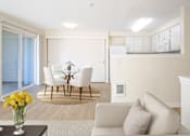 Thumbnail 4 of 15 - A living room with a white couch and a glass table with flowers on it at Troutdale Terrace, Troutdale, 97060