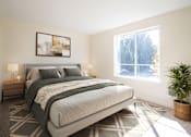 Thumbnail 7 of 15 - A bedroom with a large bed and a potted plant at Troutdale Terrace, OR, 97060