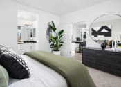 Thumbnail 23 of 35 - a bedroom with white walls and a green bedspread at Solstice at Fiddyment Ranch, California, 95747