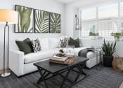 Thumbnail 21 of 35 - a living room with a white couch and black and white decor
