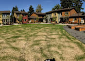 Thumbnail 15 of 25 - A grassy area in front of apartment buildings.at Bridge Meadows Beaverton 55+, Beaverton, OR 97005