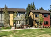 Thumbnail 9 of 25 - A row of houses with green lawns in front.at Bridge Meadows Beaverton 55+, Beaverton, OR