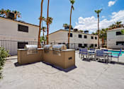 Thumbnail 5 of 22 - Outdoor grilling stations with dining area by pool at Dash Apartments, Nevada