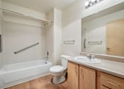 Thumbnail 47 of 48 - A white bathroom with a toilet, sink, and bathtub.at Vintage at Vancouver, Washington, 98662