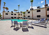 Thumbnail 8 of 22 - Outdoor pool area with lounge seating and palm trees at Dash Apartments, Nevada, 89104