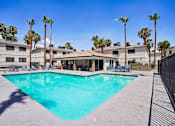Thumbnail 9 of 22 - Sparkling swimming pool with cabana and lounge seating at Dash Apartments, Las Vegas, NV 89104