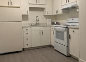 Thumbnail 23 of 24 - A white cabinet with a light on the wall at OTAVON APARTMENTS, CA 94947