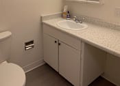 Thumbnail 24 of 24 - A white toilet with a white cabinet above it at OTAVON APARTMENTS, Novato