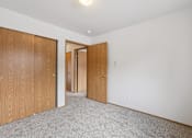 Thumbnail 33 of 74 - A room with two doors and a carpeted floor  at The Timbers by Vintage, Arlington, WA 98223