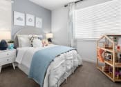 Thumbnail 12 of 35 - Bedroom with Plush Carpet Flooring, Bed, Nightstands with Lamps, Wall Decor, Accent Wall, and Two Windows with Blinds at Solstice at Fiddyment Ranch, California