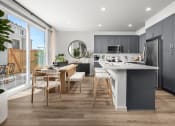 Thumbnail 1 of 35 - Kitchen with Spacious Kitchen Island, Quartz Countertops, Grey Modern Cabinets, and Stainless-Steel Appliances at Solstice at Fiddyment Ranch, California