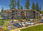 Thumbnail 26 of 26 - Building exterior and green grounds at SOUTH HILL BY VINTAGE, Puyallup, Washington