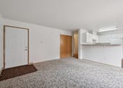 Thumbnail 69 of 74 - A room with a white door and a brown rug.
