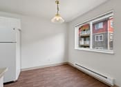Thumbnail 65 of 74 - A room with a window and a white fridge.