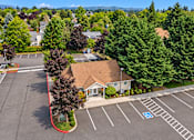 Thumbnail 3 of 30 - A parking lot with a building and a handicap parking spot.