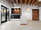 Thumbnail 41 of 81 - an empty room with a white reception desk and a sliding barn door