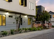 Thumbnail 51 of 81 - the exterior of a building with yellow doors and a sidewalk