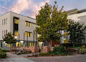 Thumbnail 48 of 81 - an exterior view of an apartment building at dusk