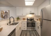 Thumbnail 1 of 38 - Modern Kitchen with Stainless-Steel Appliances and White Cabinetry at THE ARLO, Citrus Heights, 95621