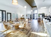 Thumbnail 9 of 12 - A modern living room with wooden floors and furniture.