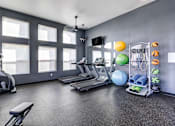 Thumbnail 6 of 12 - A gym with treadmills, weights, and exercise balls at AGAVE APARTMENTS, Elk Grove, 95757