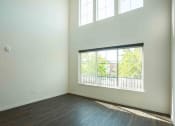 Thumbnail 23 of 41 - an empty bedroom with a large window and hardwood floors at THE ANGELINO, Sacramento California