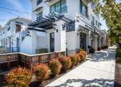 Thumbnail 12 of 41 - a white apartment building with a sidewalk in front of it at THE ANGELINO, Sacramento, 95819