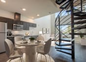 Thumbnail 1 of 41 - a kitchen and dining area with a spiral staircase leading up to the second floor at THE ANGELINO, Sacramento