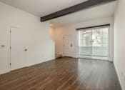Thumbnail 24 of 41 - a bedroom with hardwood floors and white walls at THE ANGELINO, California