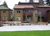 Thumbnail 14 of 16 - A row of houses with a green lawn in front.at Bridge Meadows North Portland 55+, Portland, OR 97203