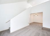 Thumbnail 11 of 24 - Townhome style layout with high ceilings and staircase leading upstairs at Devonwood and First Place Apartments, Battle Ground Washington