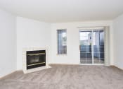 Thumbnail 10 of 24 - Living area with fireplace and balcony at Devonwood and First Place Apartments, Washington