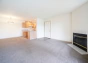 Thumbnail 8 of 24 - Living Room with Plush Carpeting and an Interior Fireplace at Devonwood and First Place Apartments, Battle Ground, 98604